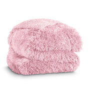 A shaggy faux fur blanket folded