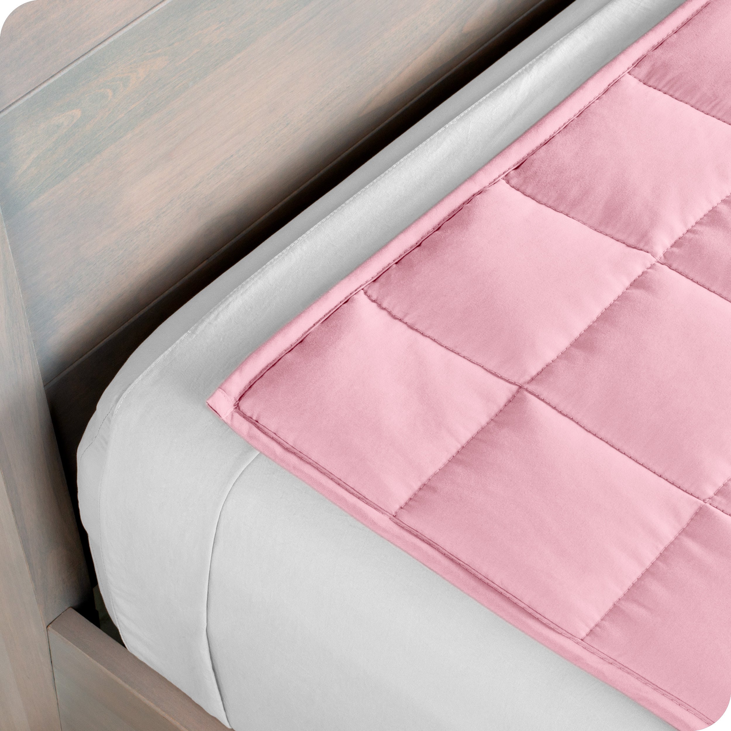Close up of the corner of a weighted blanket on a bed