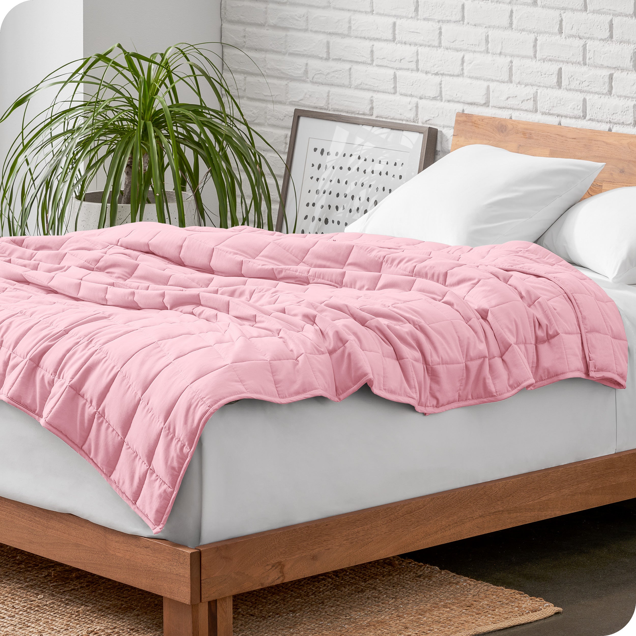 A cotton weighted blanket is loosely draped over a bed