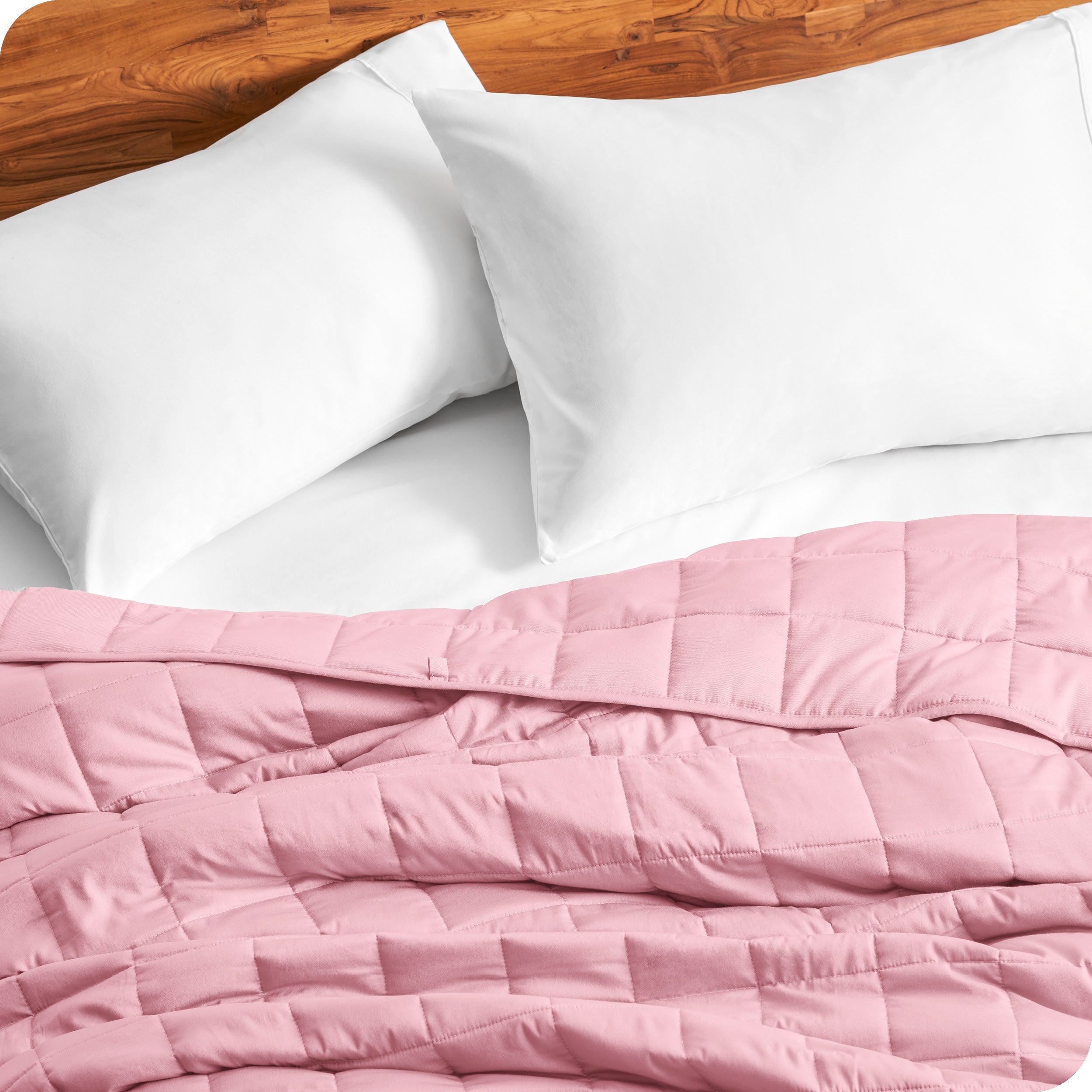 Close up of a weighted blanket on a bed with  2 pillows