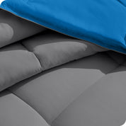 Close up of the reversible comforter showing the box stitching and the two colors