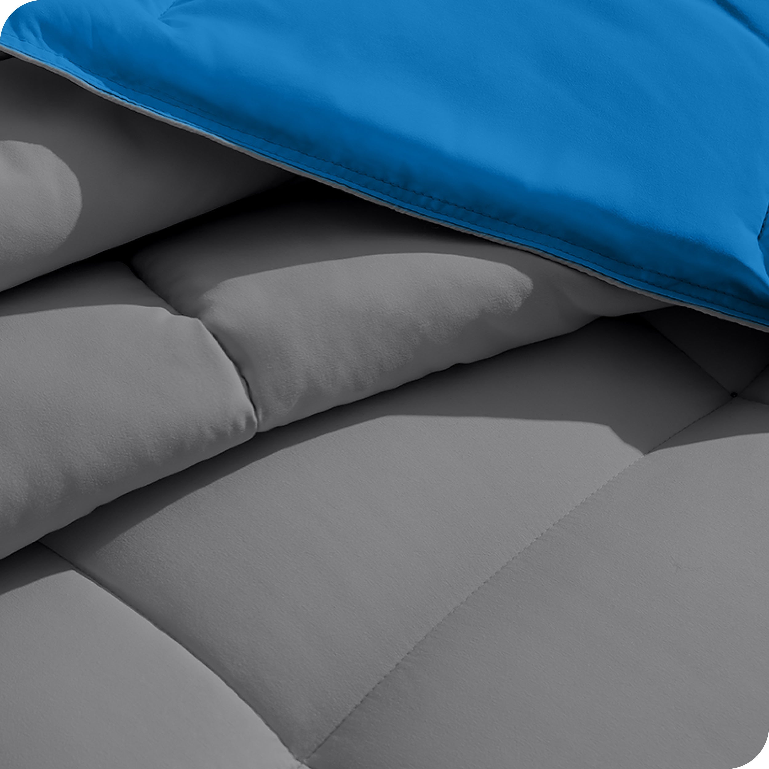Close up of the reversible comforter showing the box stitching and the two colors