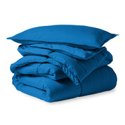 A microfiber comforter folded neatly with a pillow from above