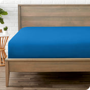 End of bed view with fitted sheet made on the mattress of a modern bed. 