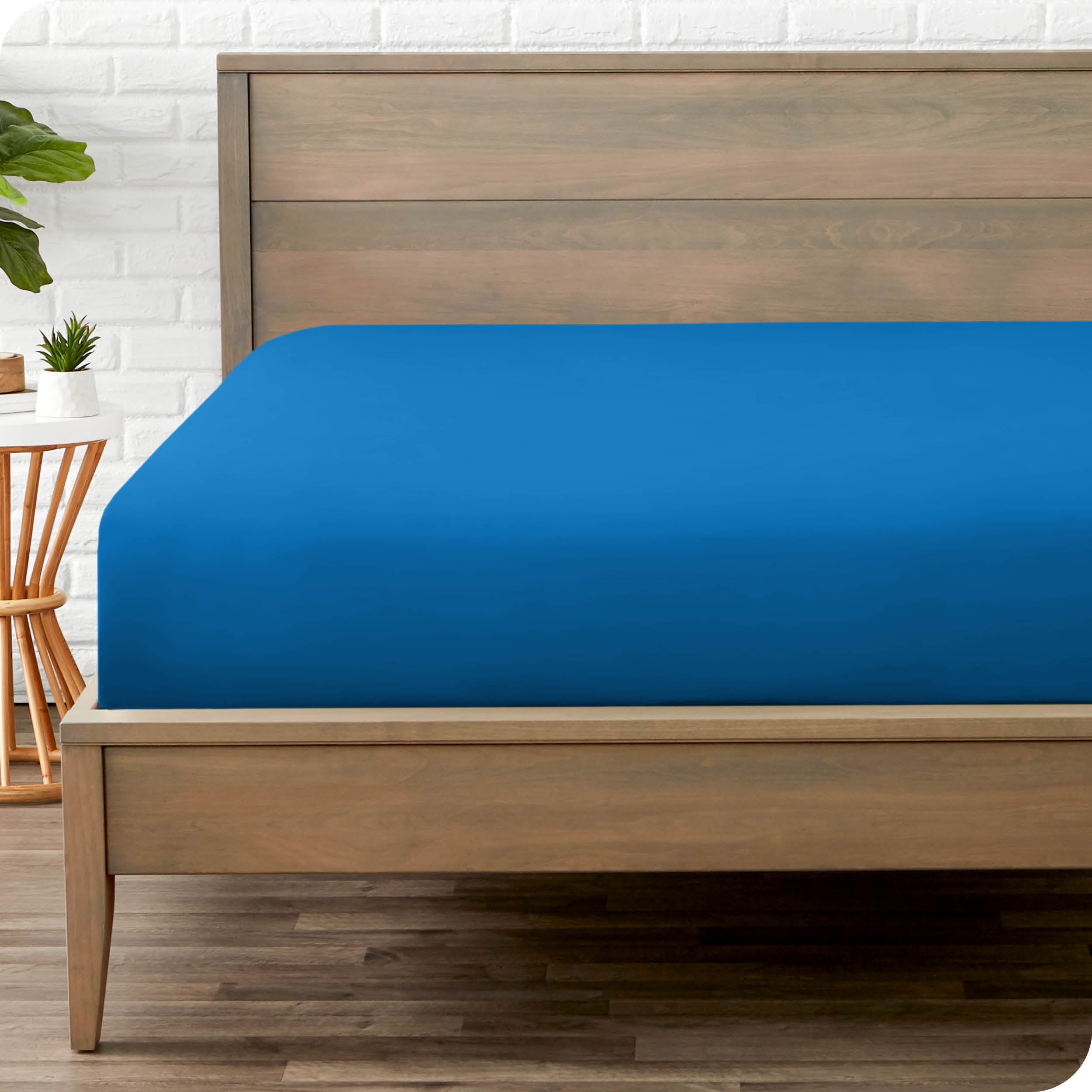 End of bed view with fitted sheet made on the mattress of a modern bed. 