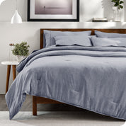 A bedding set on a bed in a modern bedroom