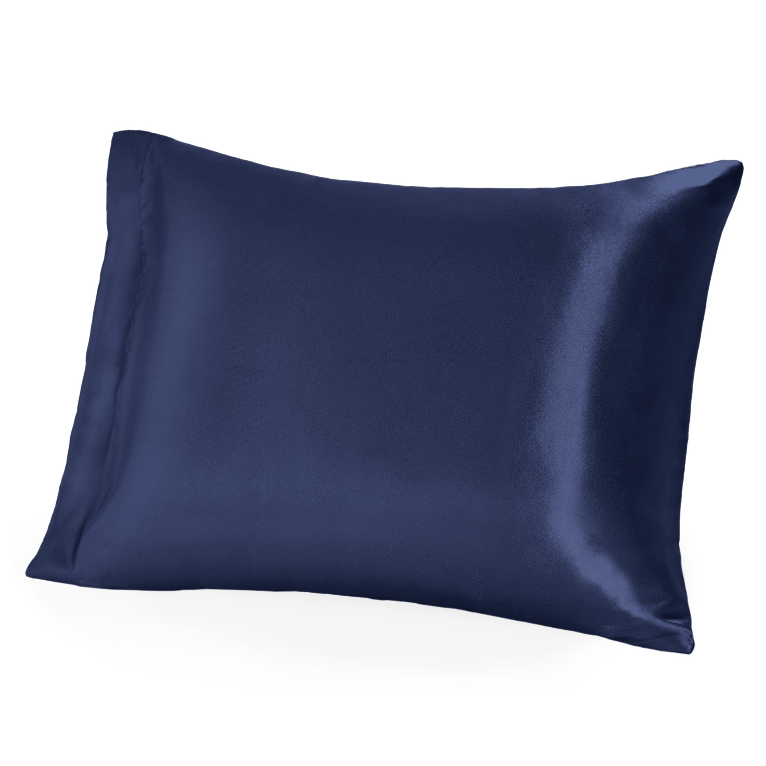 A woman on a bed resting her arm on a silk pillowcase covered pillow