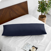A body pillowcase on a pillow on a bed with all white bedding