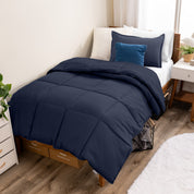 A modern bed with a down alternative comforter set on it