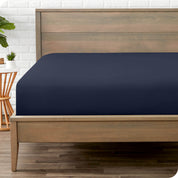 End of bed view with fitted sheet made on the mattress of a modern bed. 