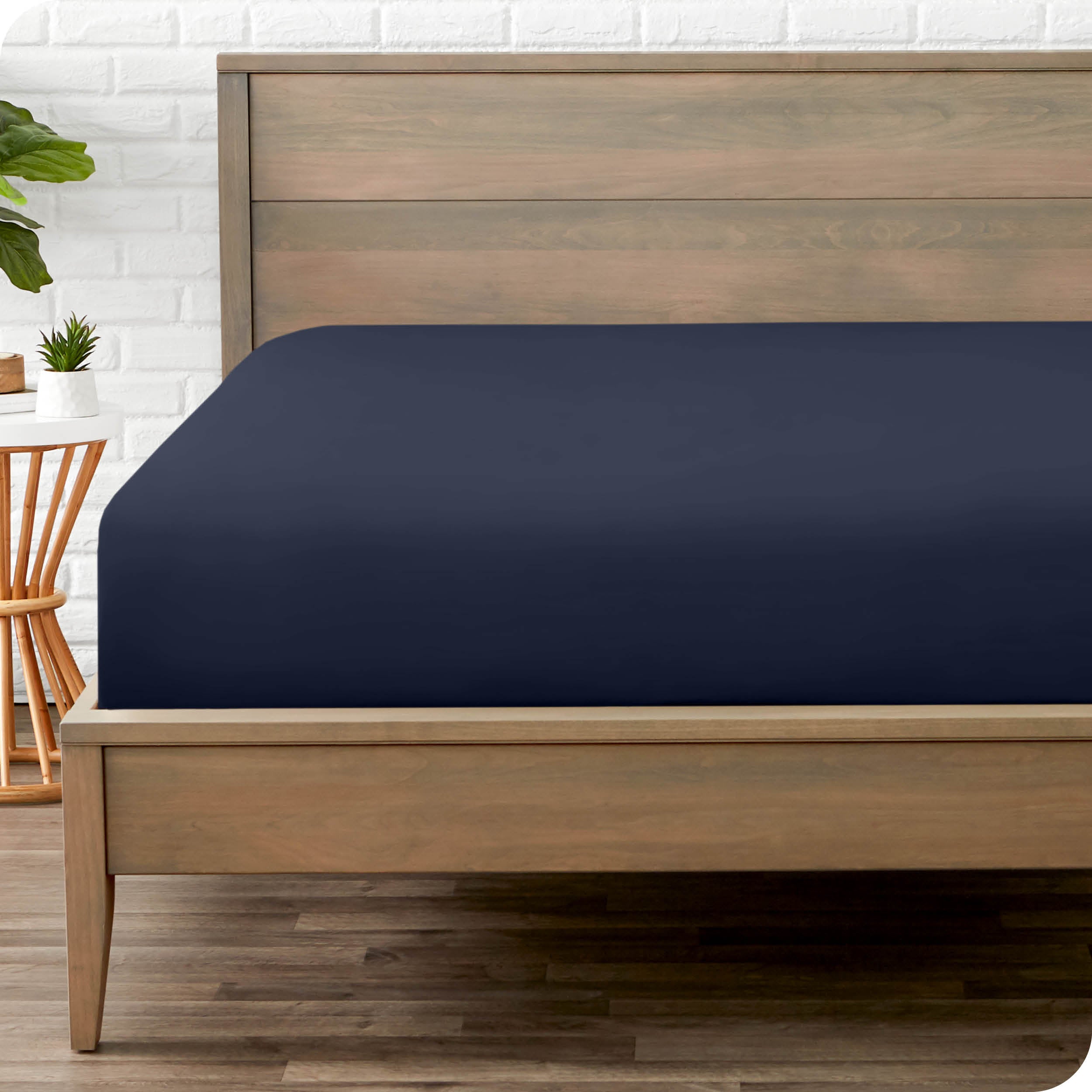 End of bed view with fitted sheet made on the mattress of a modern bed. 