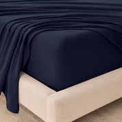 Organic flannel sheets on a beige bed frame