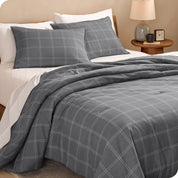 A side view of a bed made with a track stitch comforter set