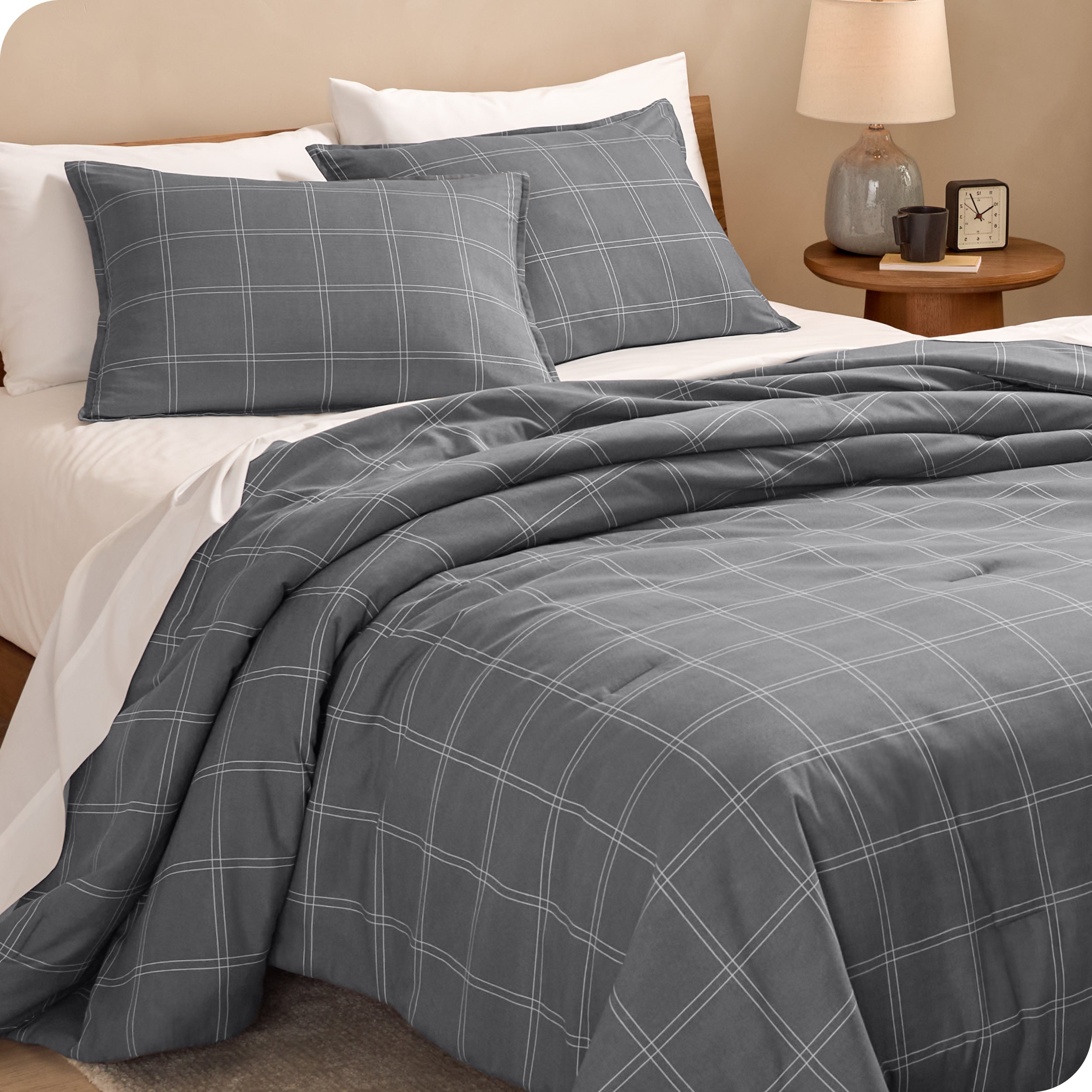 A side view of a bed made with a track stitch comforter set