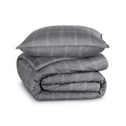 A comforter folded with a matching pillow sham stacked on top