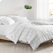 A side view of a bed made with a track stitch comforter set