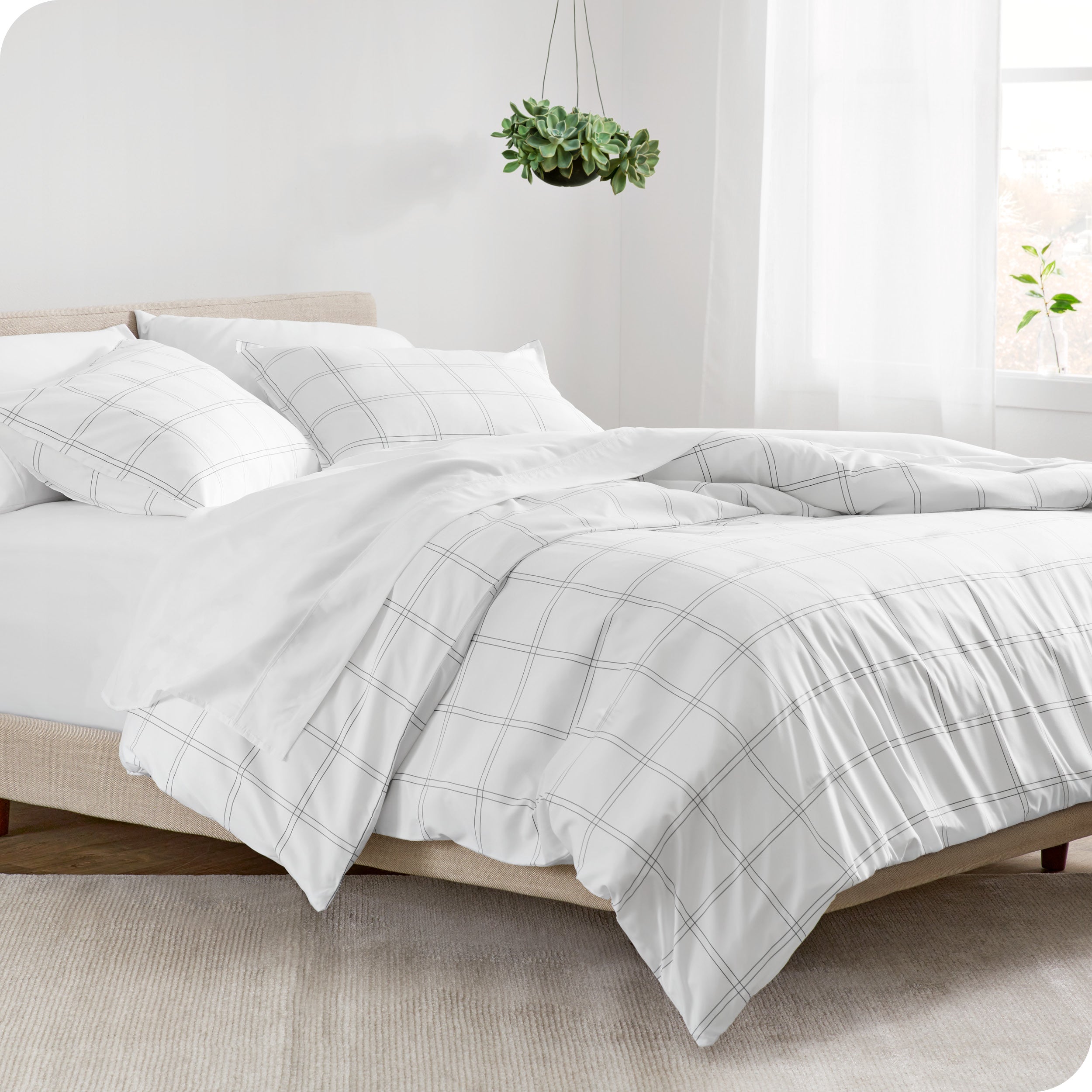 A side view of a bed made with a track stitch comforter set