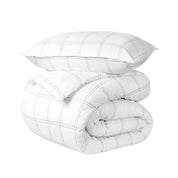 A comforter folded with a matching pillow sham stacked on top