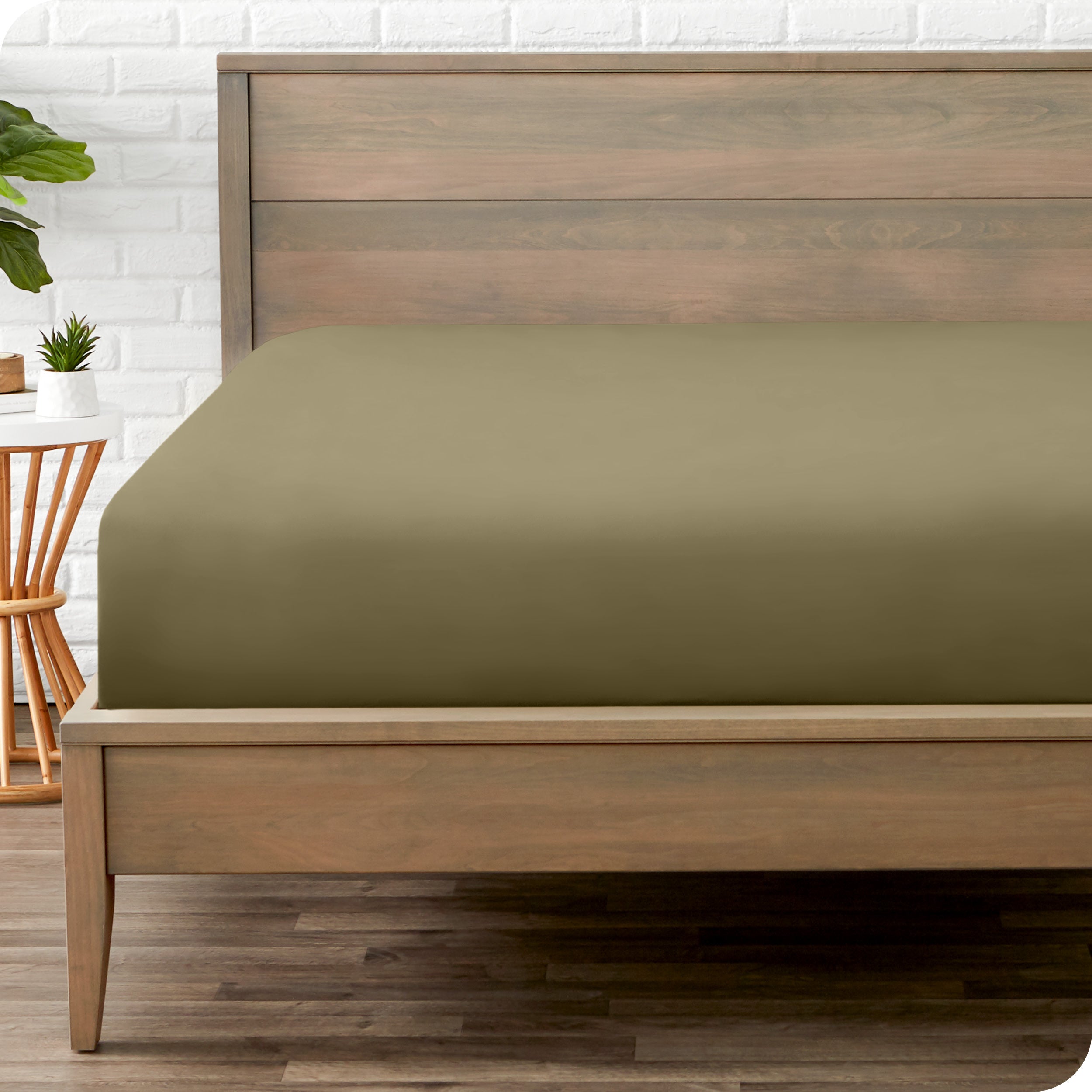 End of bed view with fitted sheet made on the mattress of a modern bed. 