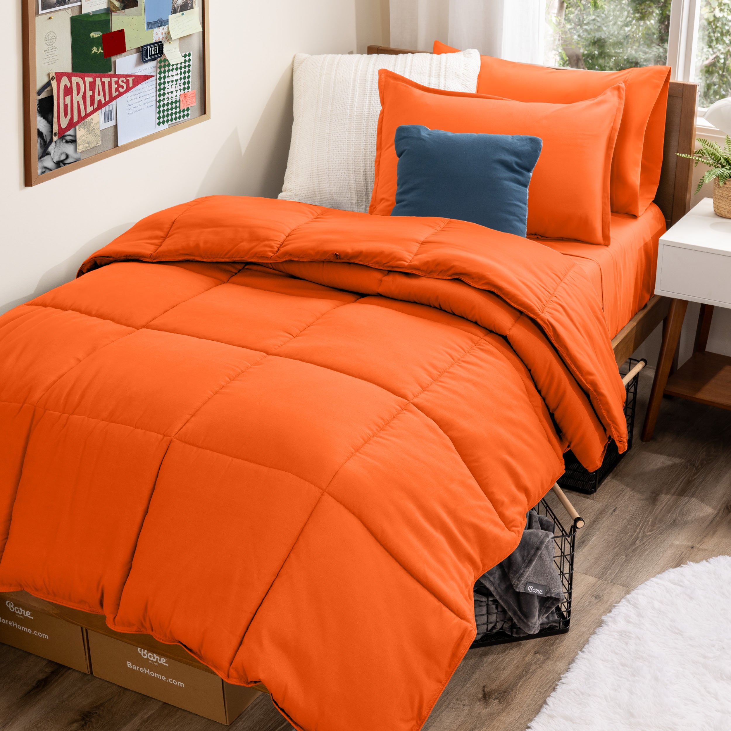 A college dorm room with a bed in a bag set on the mattress