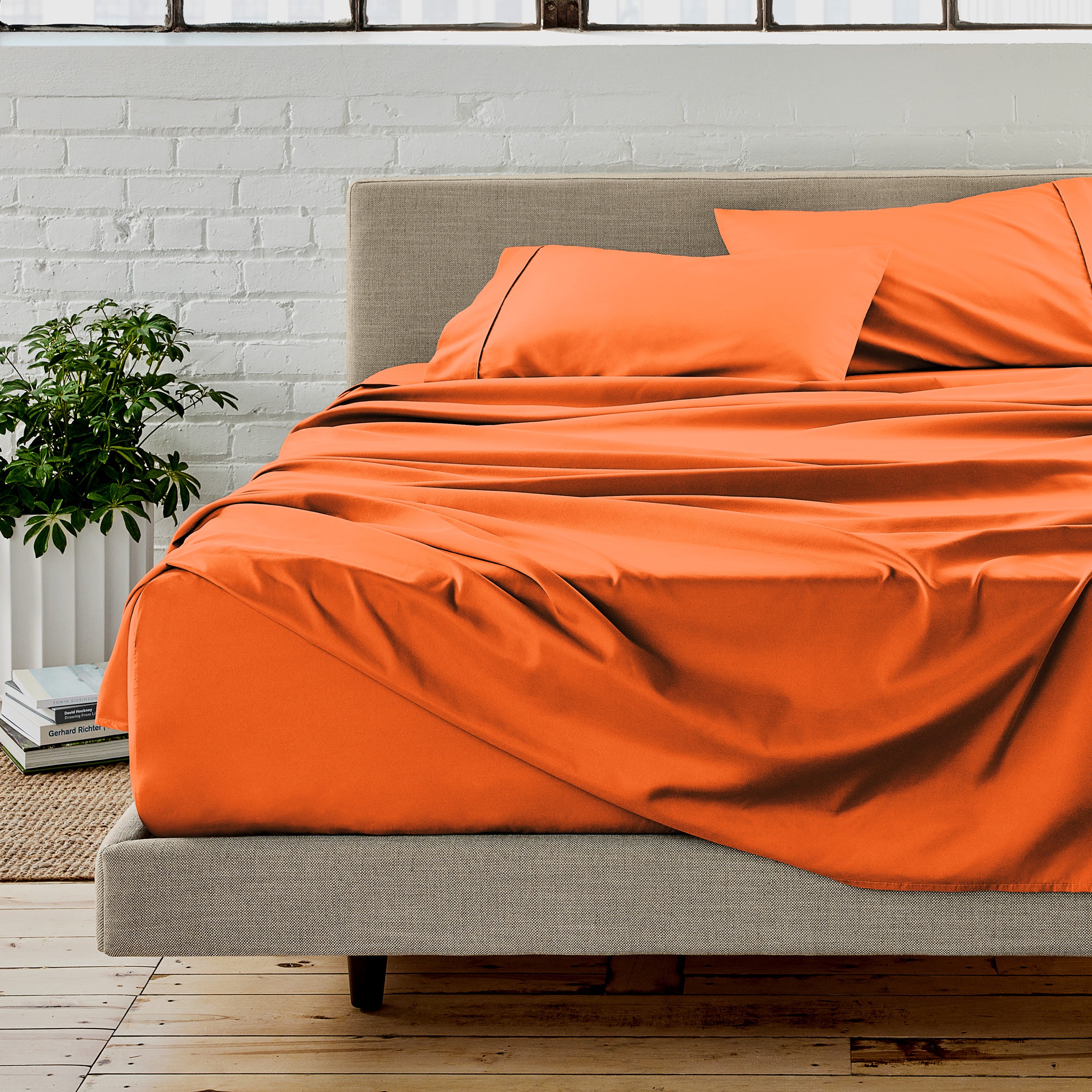 Microfiber sheet set on a bed with a white brick wall in the background
