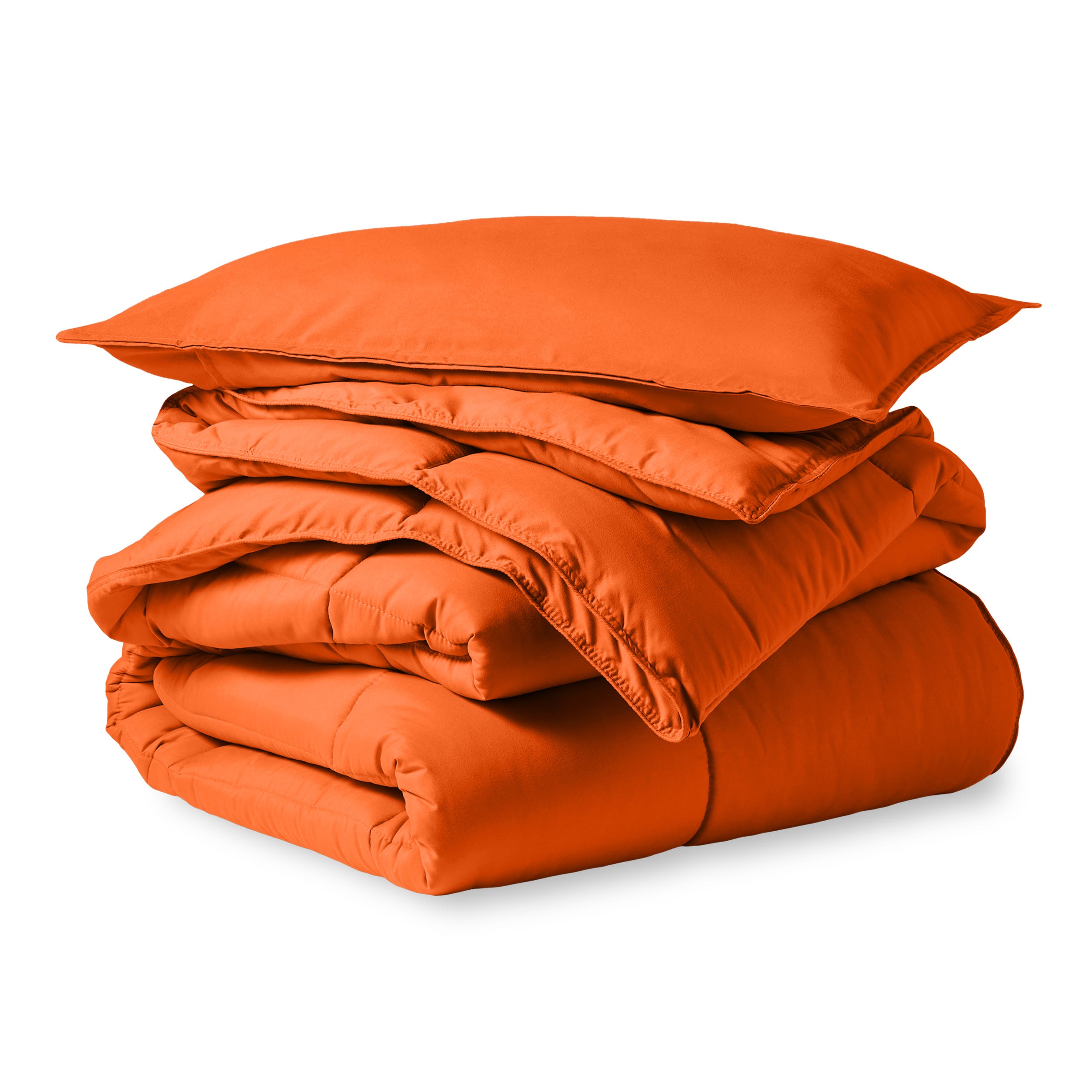 A microfiber comforter folded neatly with a pillow from above