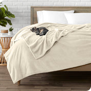 Microplush blanket laid out over a bed and folded back over itself