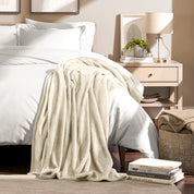 Microplush blanket laid out over a bed and folded back over itself
