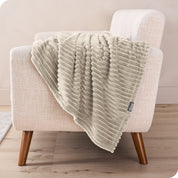 A blanket is draped over the arm of a small chair