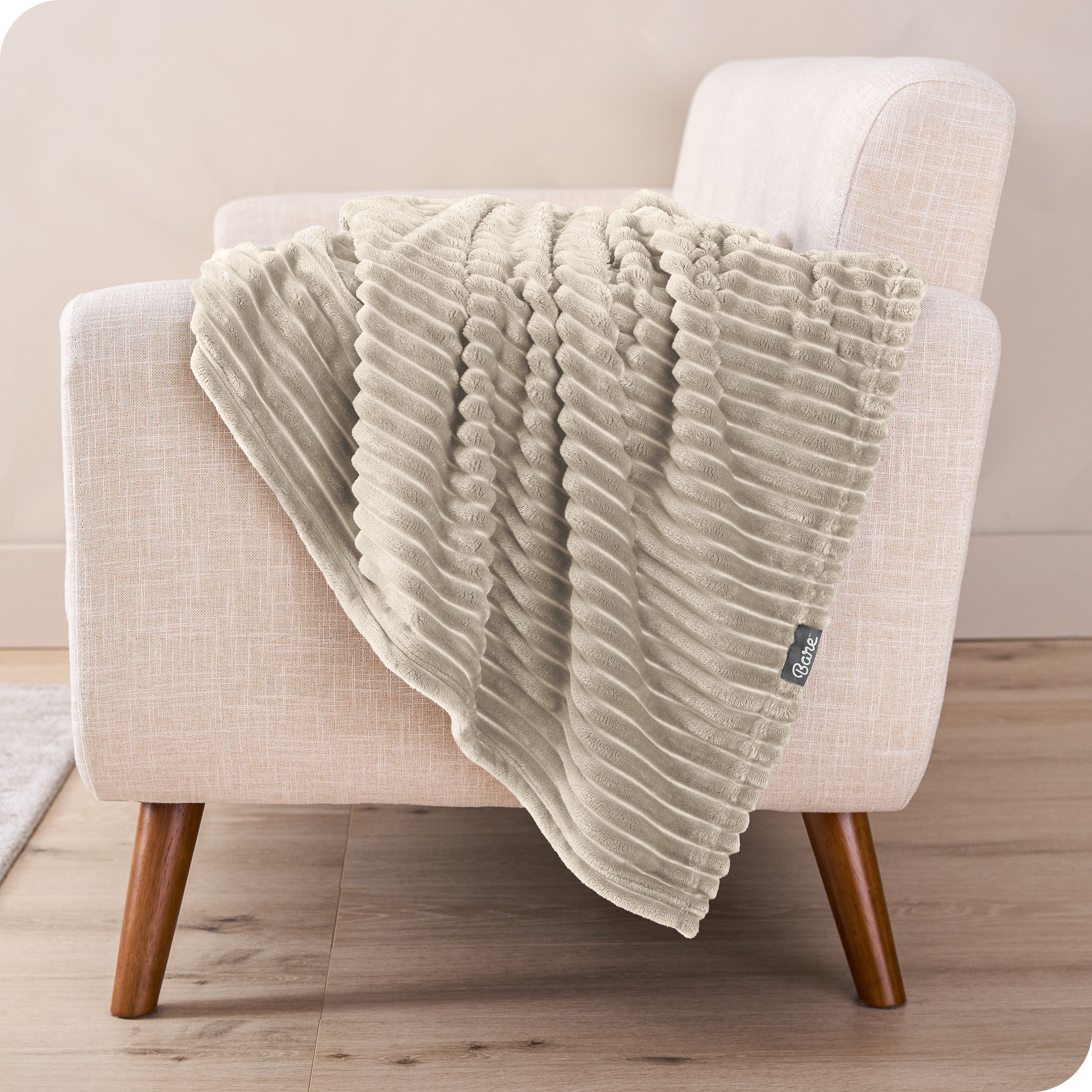 A blanket is draped over the arm of a small chair