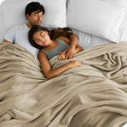 A couple sleeping while covered with a microplush blanket
