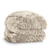 A shaggy faux fur blanket folded