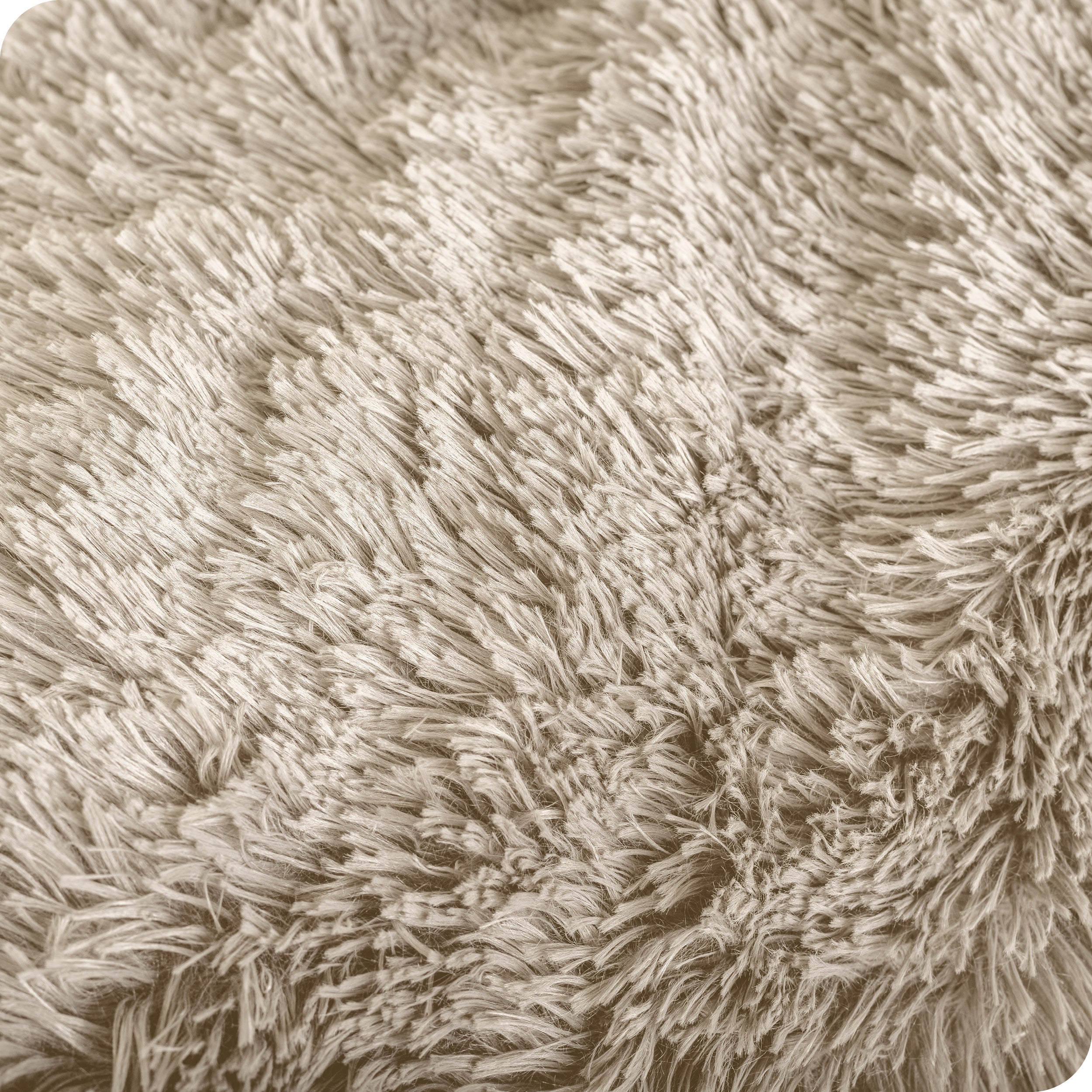 A shaggy faux fur blanket draped over the arm of a chair