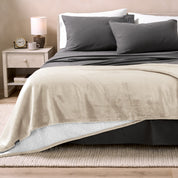 Sherpa Blanket laying on a bed folded over itself part way