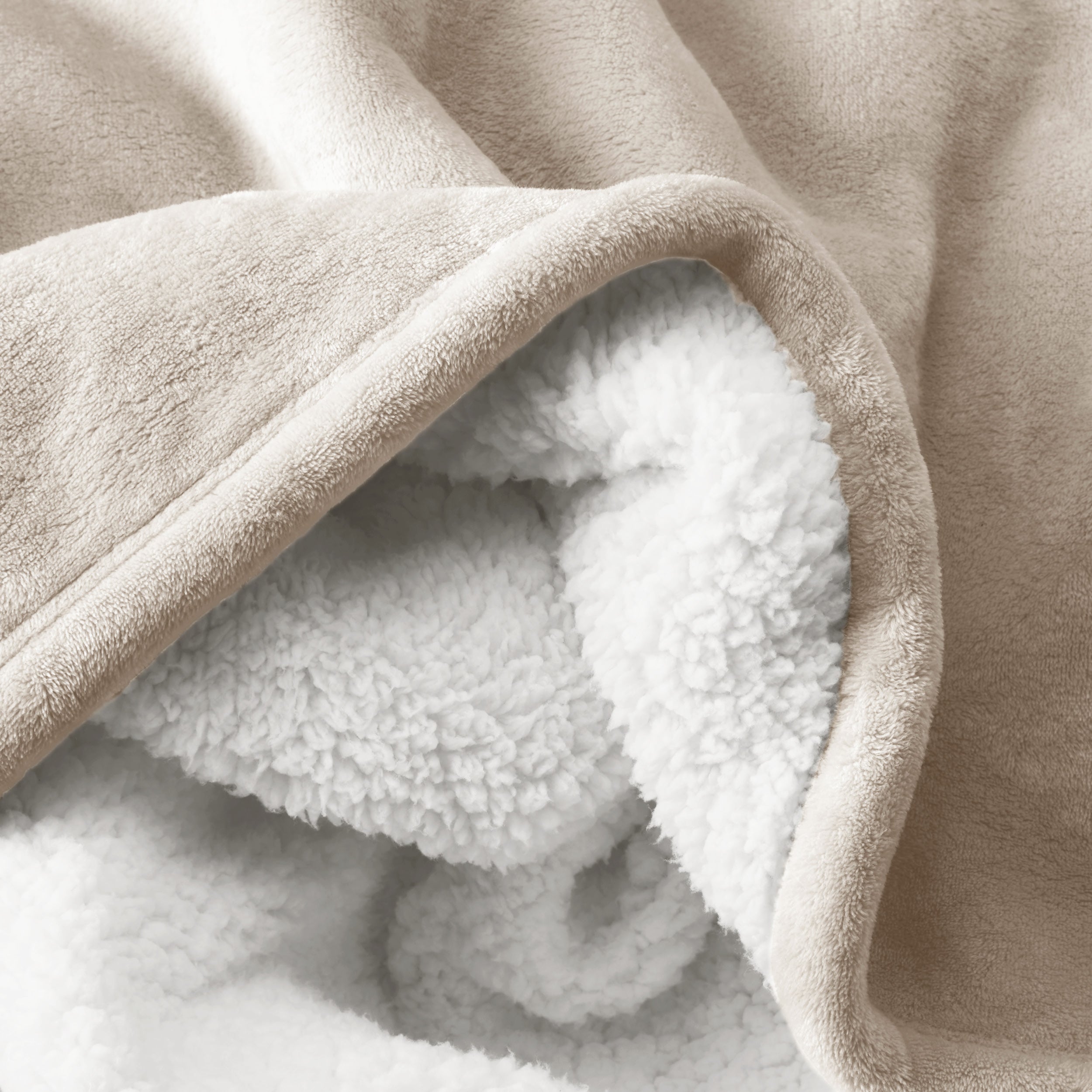 Close up of sherpa blanket showing texture of velvety soft side and sherpa backing