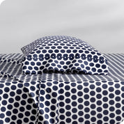 A sideview of a modern bed with a printed microfiber sheet set.