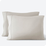 Two pillowcases on a white background with print pillowcases on them.