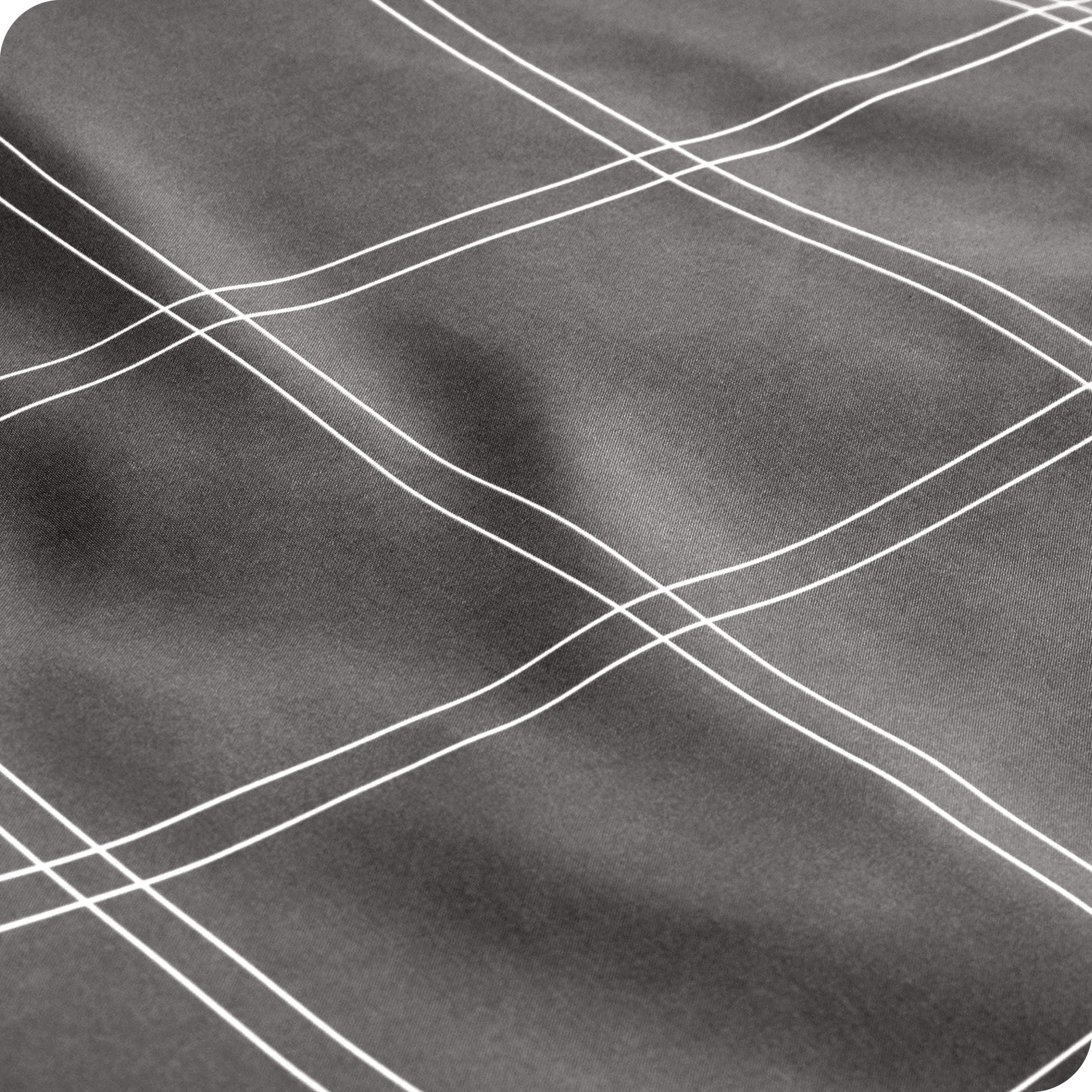 Close up view of the corner of a mattress with the microfiber fitted sheet to show how it fits. 