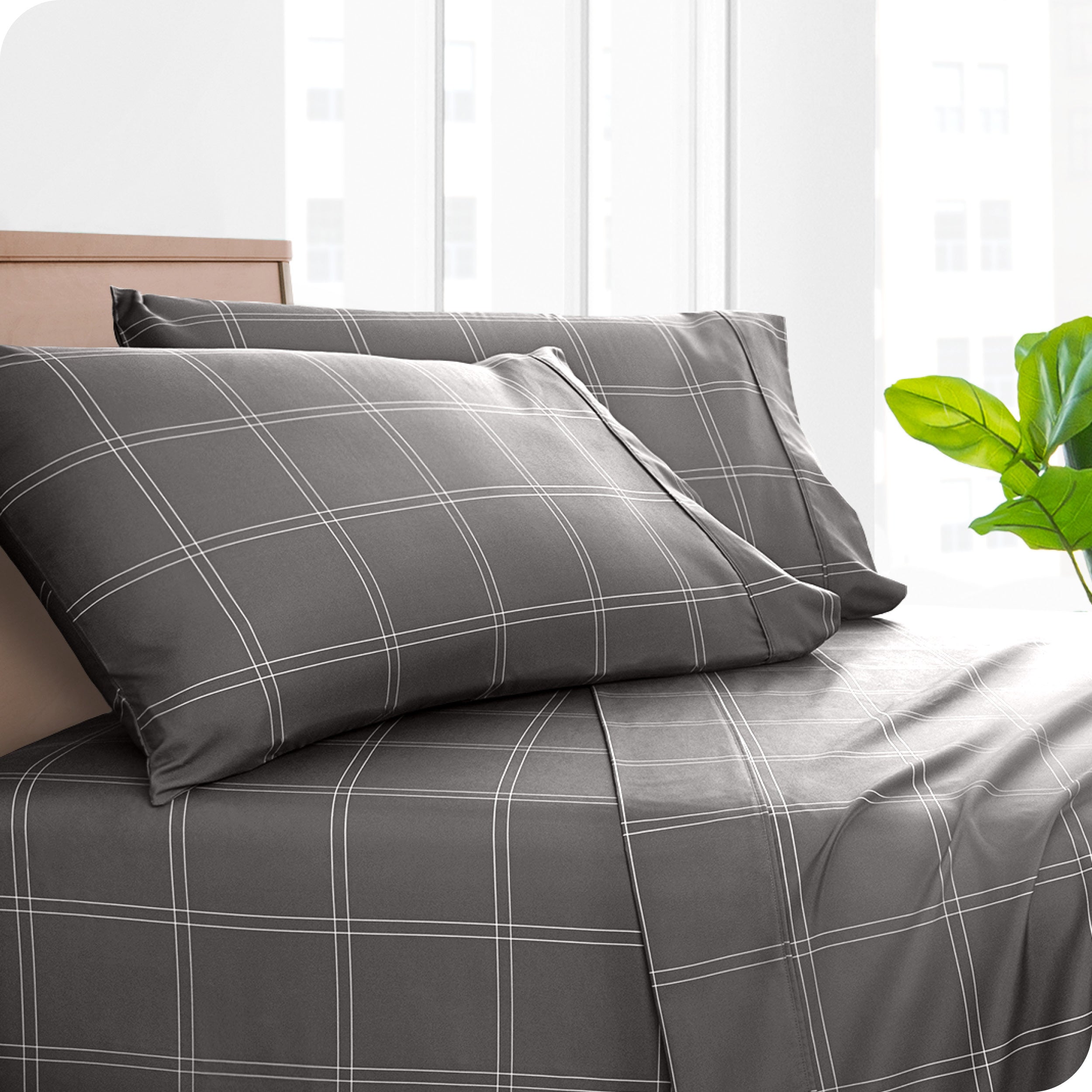 Two pillowcases on pillows on a bed with matching sheets