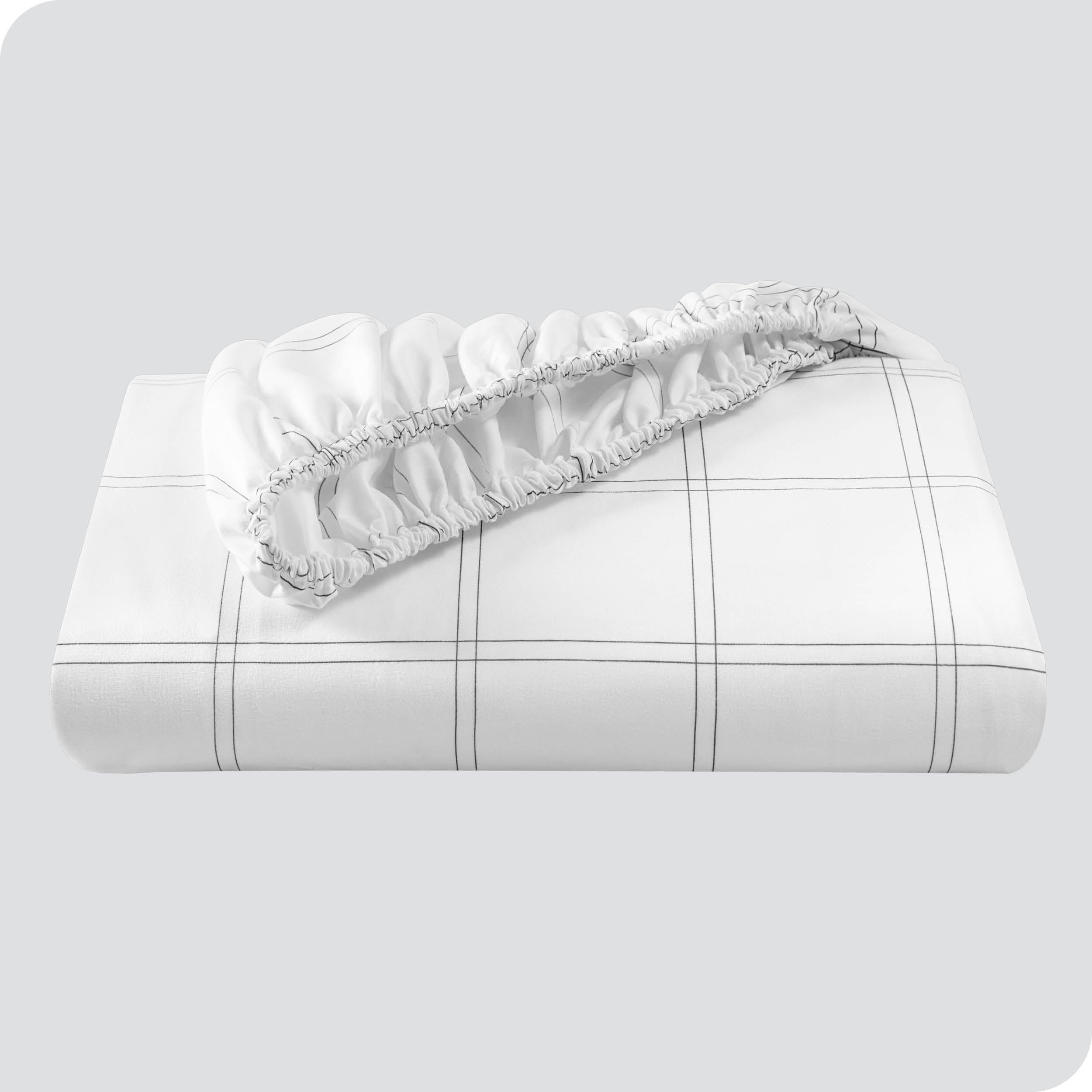 A neatly folded printed microfiber fitted sheet with elastic draped. 