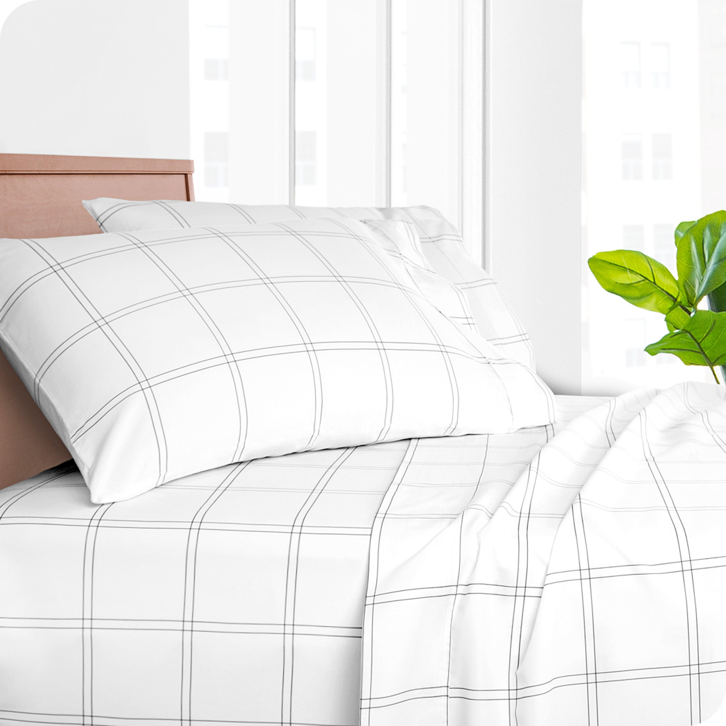 Two pillowcases on pillows on a bed with matching sheets