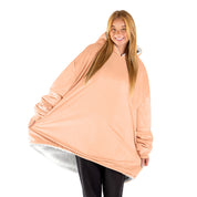 An adult with a sherpa wearable blanket on