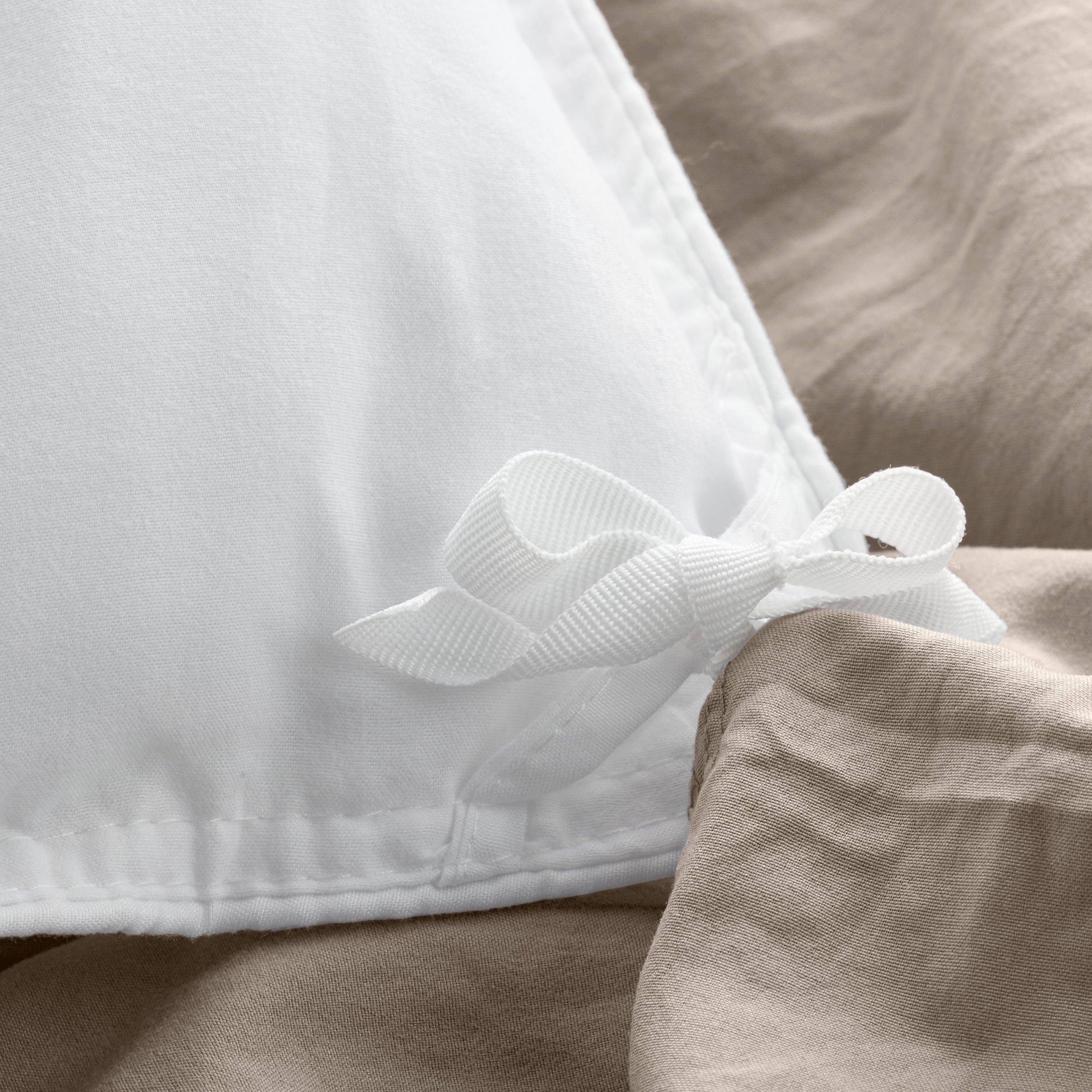 Close up of cloth ties for attaching duvet insert to inside of duvet cover