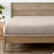 End of bed view with fitted sheet made on the mattress of a modern bed. 