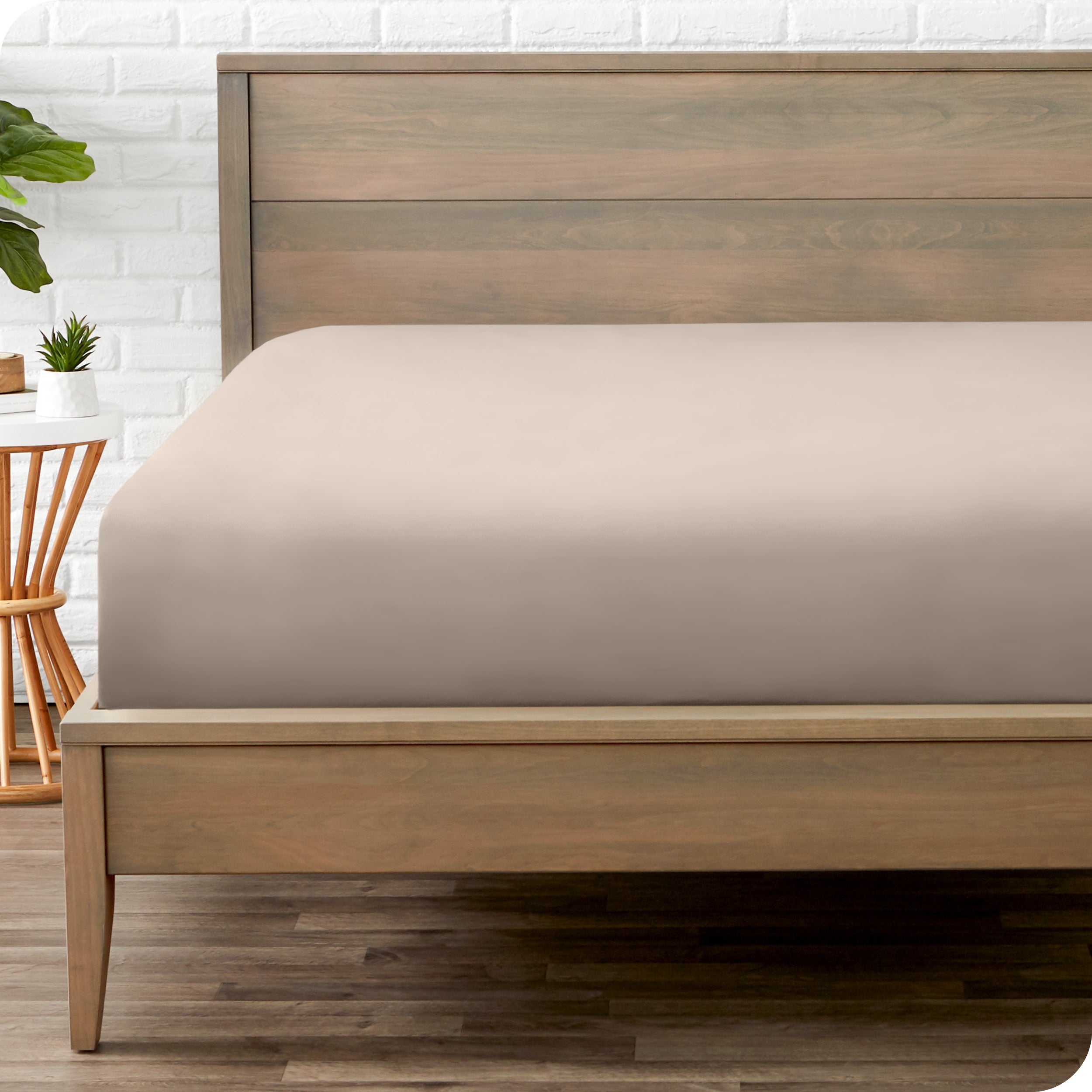 End of bed view with fitted sheet made on the mattress of a modern bed. 