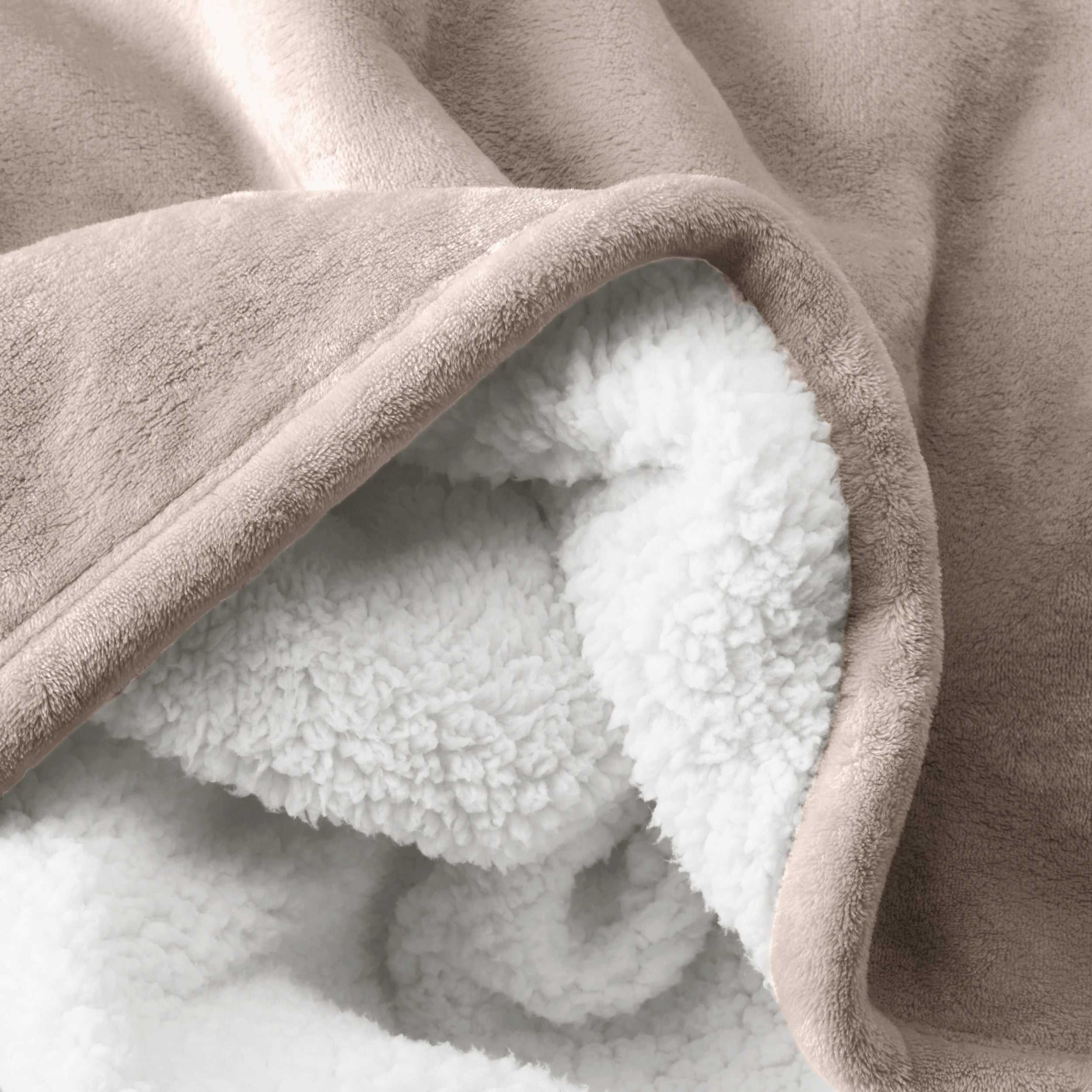 Close up of sherpa blanket showing texture of velvety soft side and sherpa backing
