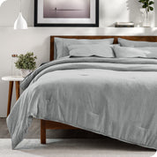 A bedding set on a bed in a modern bedroom