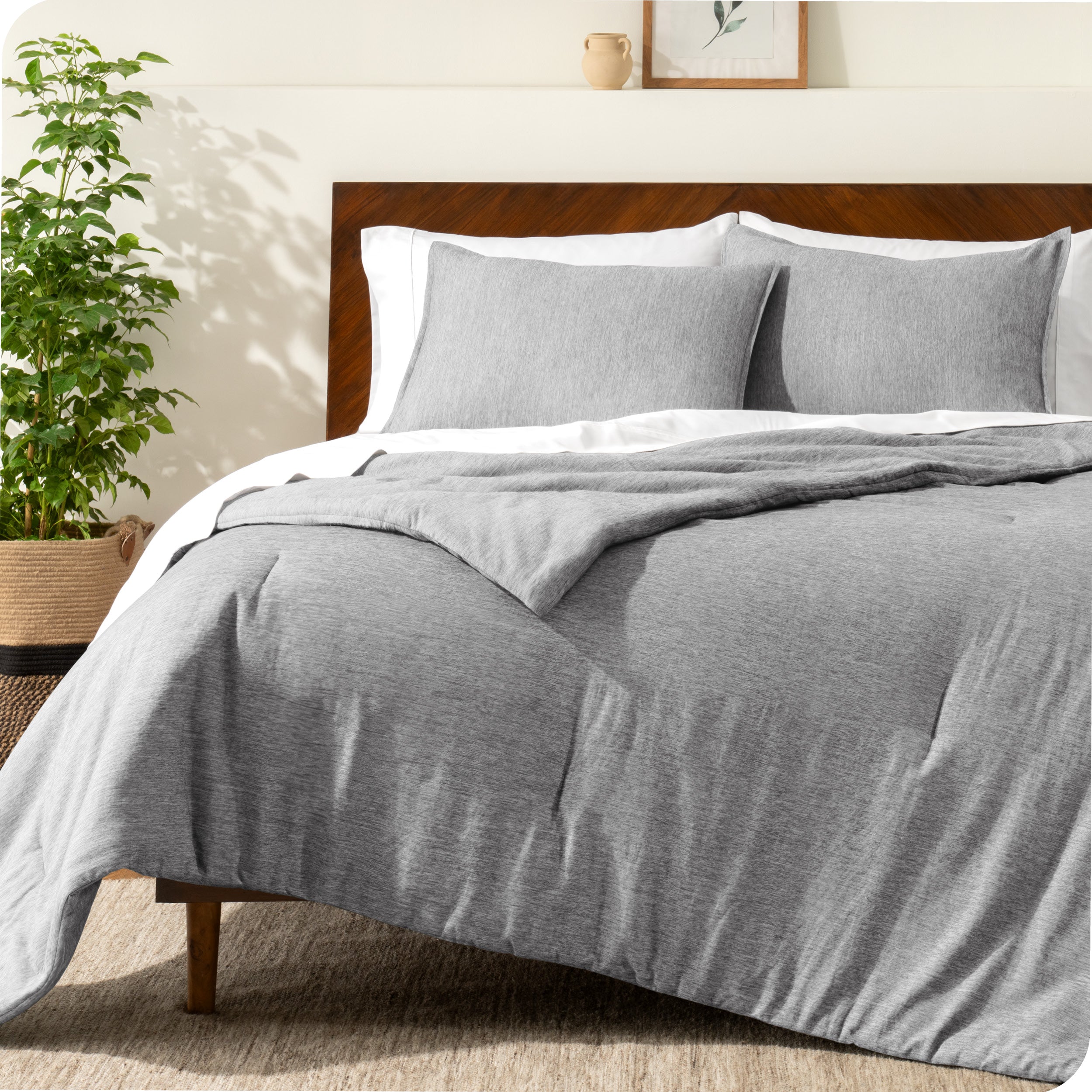 A modern bed with a down alternative comforter set on it
