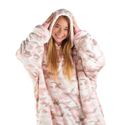 An adult with a sherpa wearable blanket on