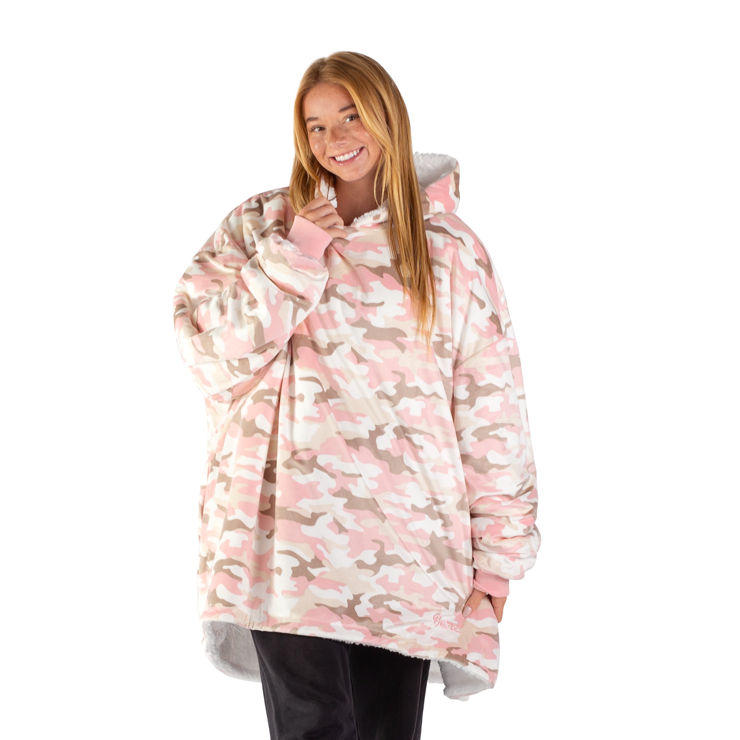 An adult with a hooded wearable blanket on